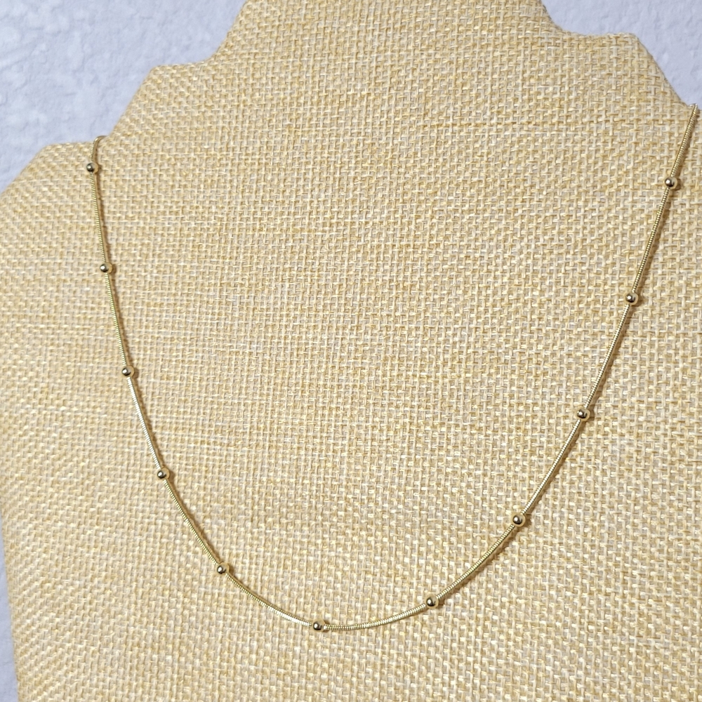 It's a thin, gold-plated beaded necklace that's sweat, water,